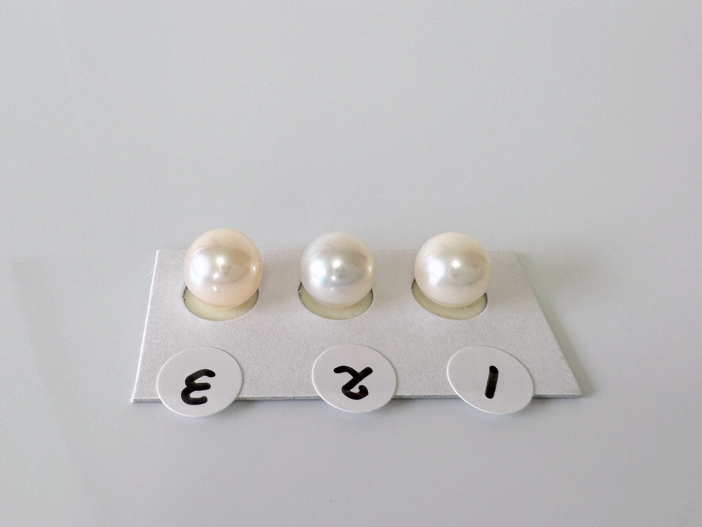 three pearls sitting on top of a piece of paper