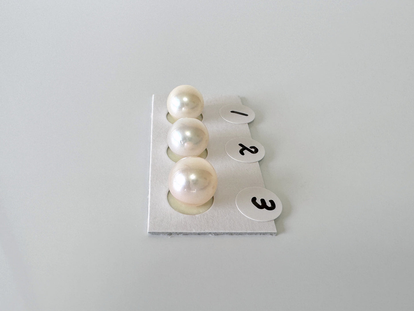a couple of pearls sitting on top of a piece of paper