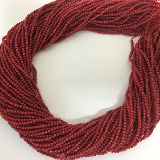 A large collection of red beads arranged in a circular pattern.