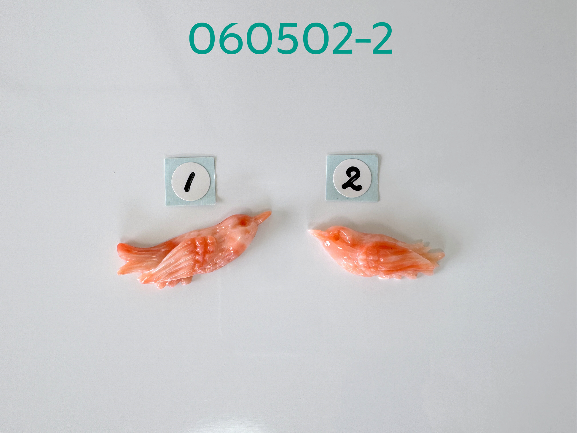 two pieces of fish on a white surface