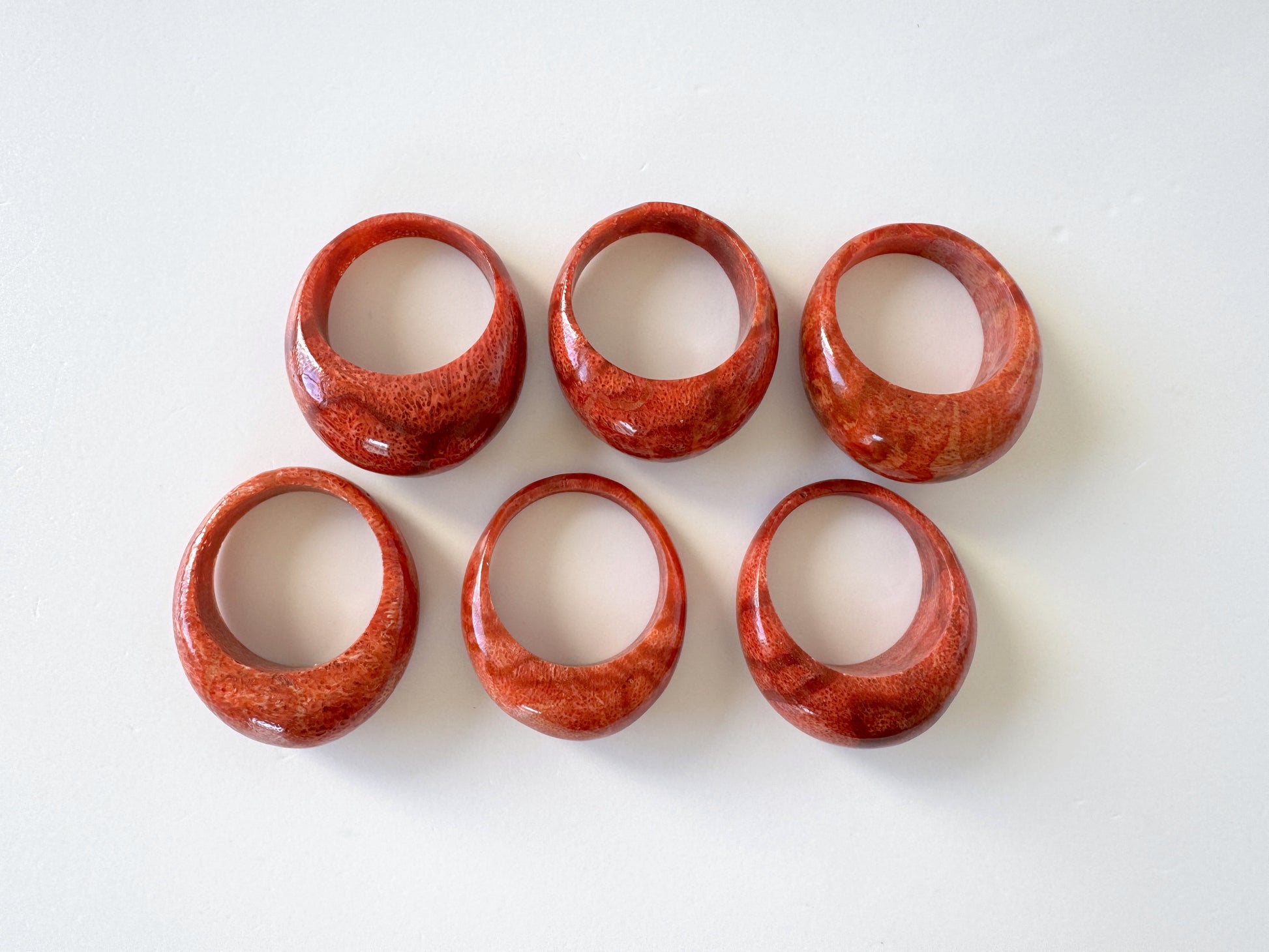 Six red, oval-shaped rings are arranged in a grid on a white background.