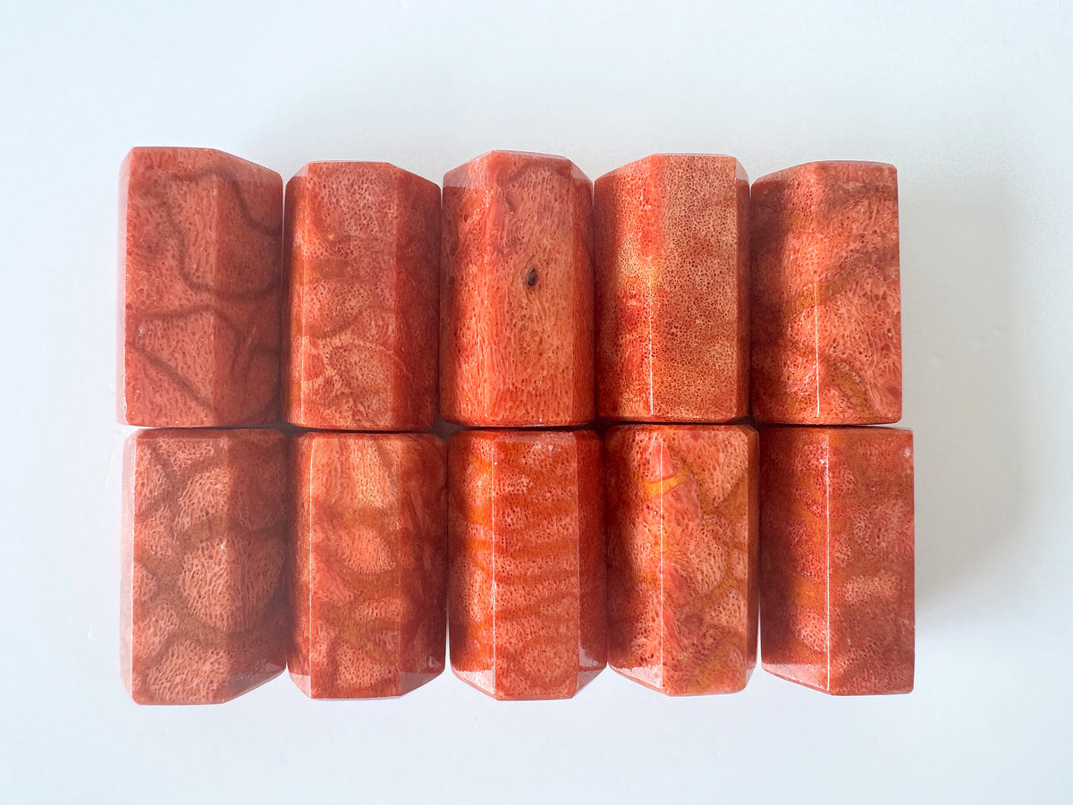 a collection of nine rectangular, textured objects with a reddish-orange hue, arranged in a grid-like pattern on a white background.