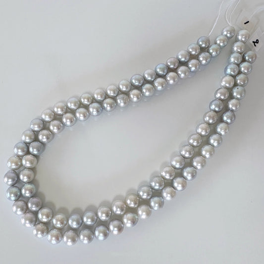 A necklace composed of numerous silver-colored pearls arranged in a circular pattern.