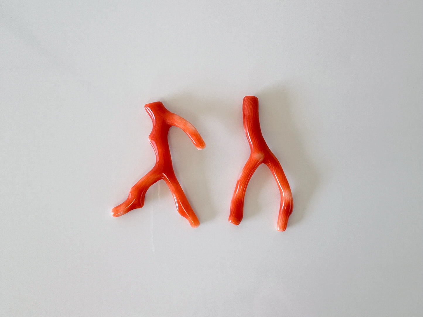 a pair of orange plastic scissors sitting on top of a table