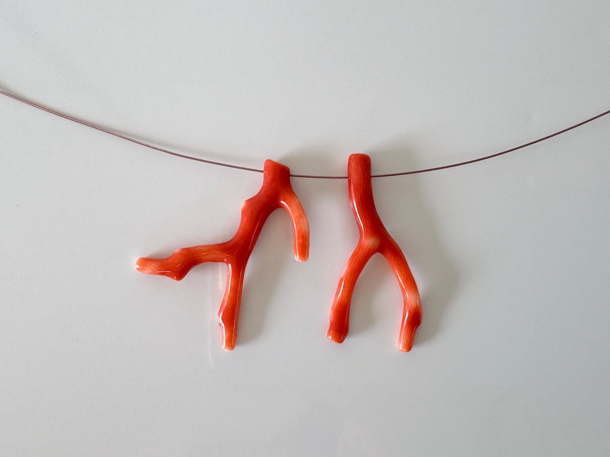 a pair of orange scissors hanging on a string