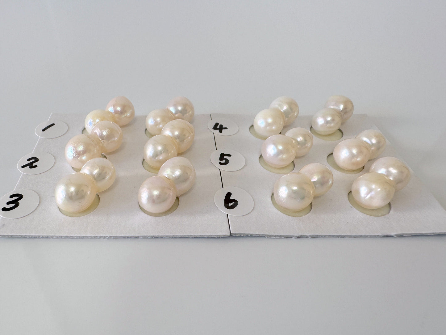 a group of pearls sitting on top of a piece of paper