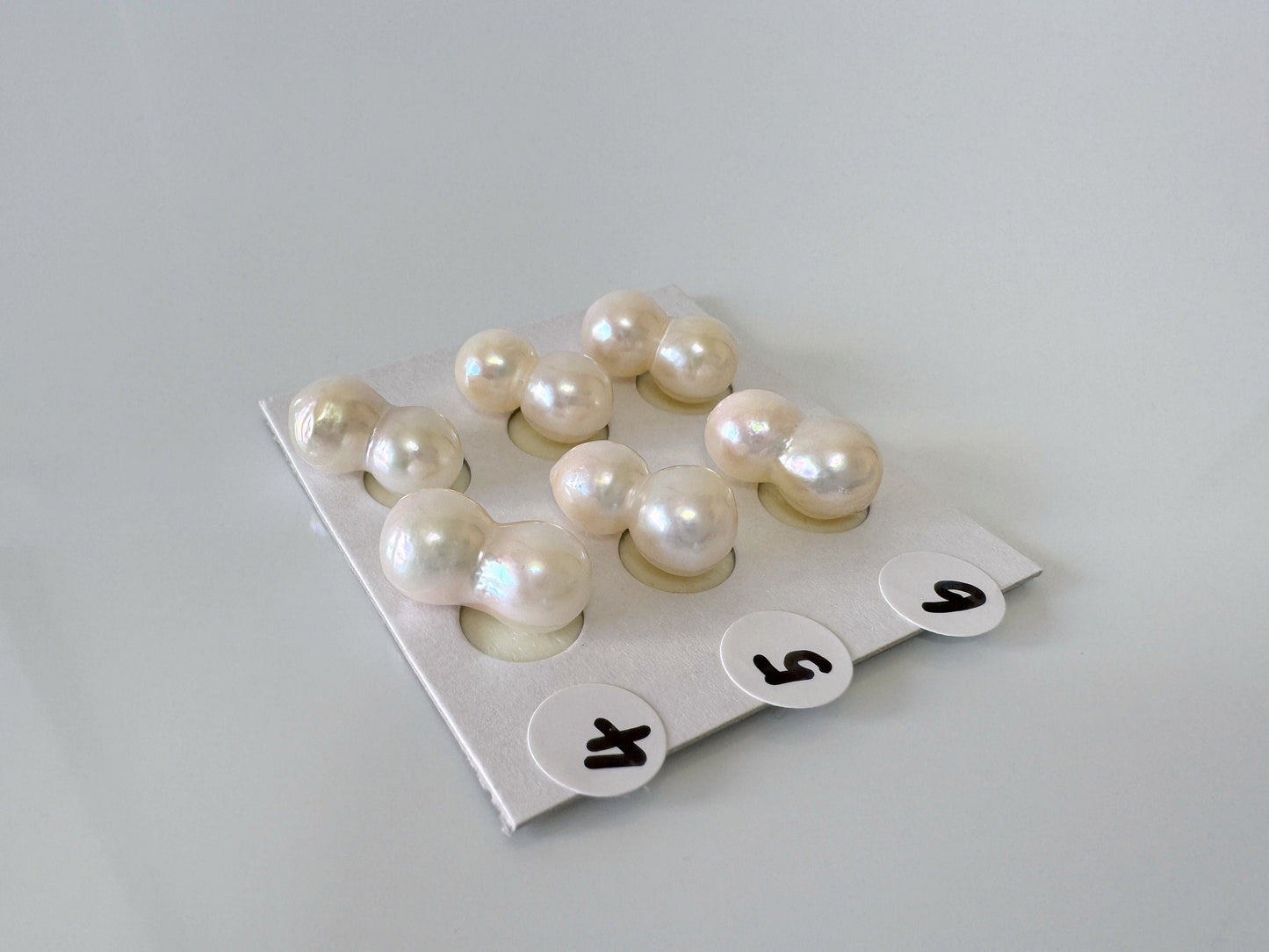 a bunch of pearls sitting on top of a piece of paper