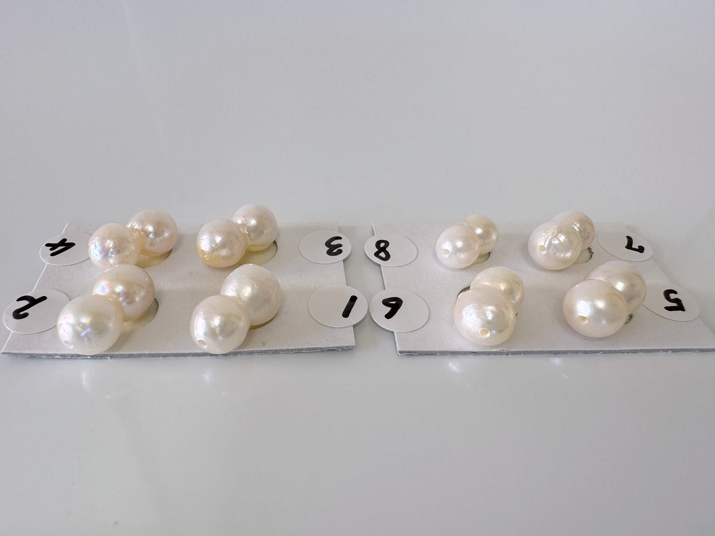 a number of pearls on a white surface