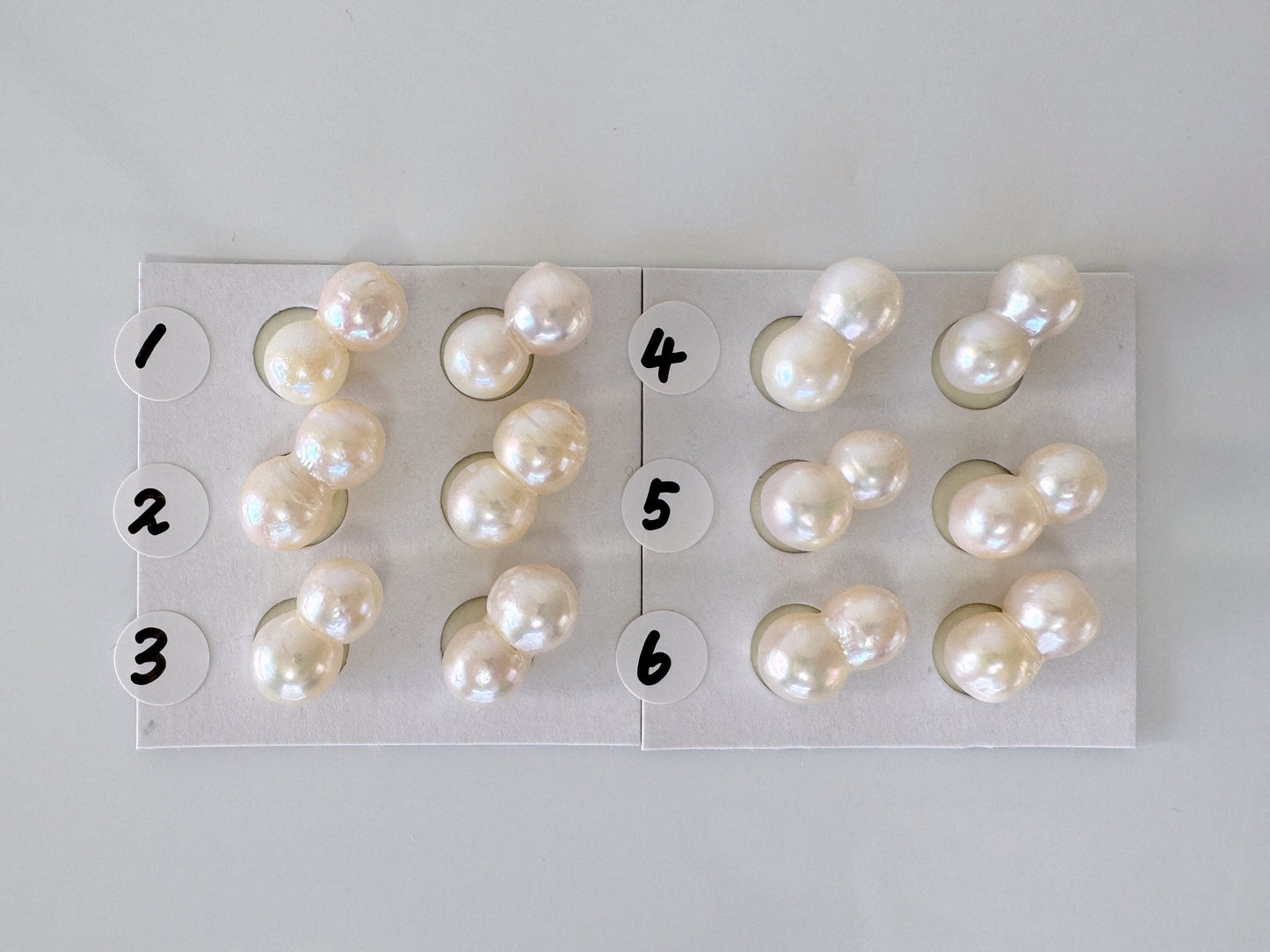 a number of pearls arranged on a sheet of paper