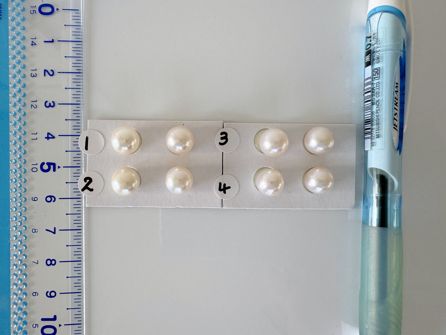 a ruler and some pearls on a table