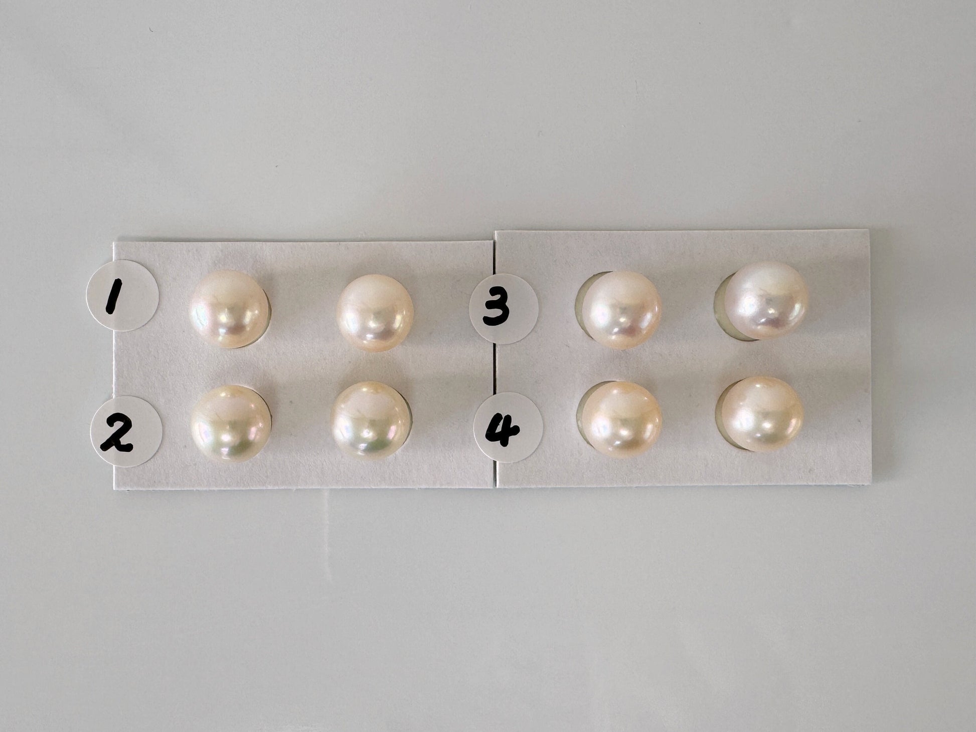 a group of pearls sitting on top of a white board